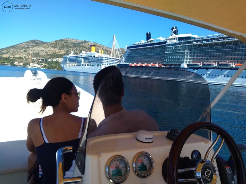 Guests on a small boat in Gruž harbour, with cruise ships moored behind